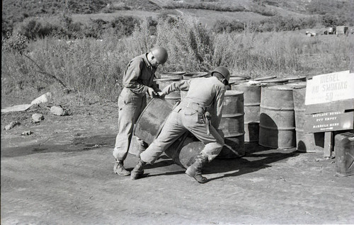 Soldier filling gas cans