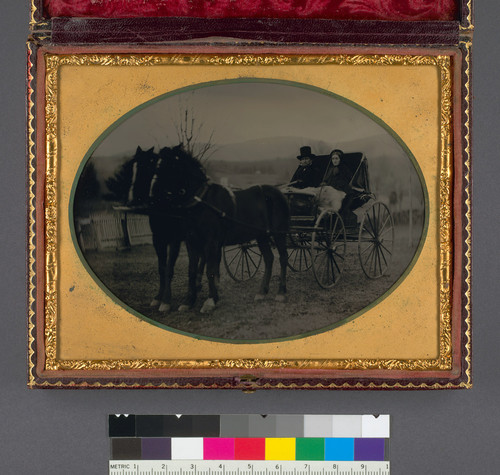 [Couple in carriage drawn by a two-horse team.]