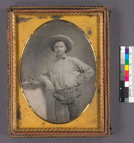 [Alonzo J. Doolittle in miner's clothing with a bag of gold]