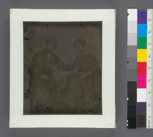 [Unidentified couple seated at a table.]