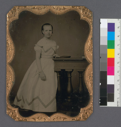 [Full length portrait of Maye C. Bourn, standing, with arm at side.]