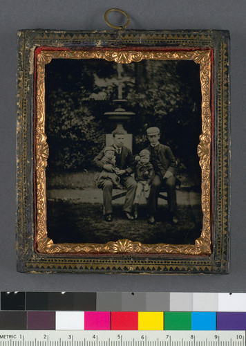 [Two men with children in a park.]