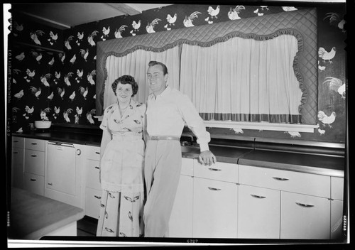 Ladd, Alan, residence. Alan Ladd and Sue Carol [wife] in kitchen