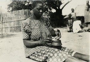 Young African woman doing pottery