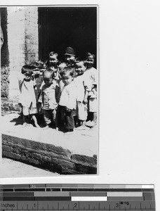 A Maryknoll Sister with small orphans at Luoding, China, 1934