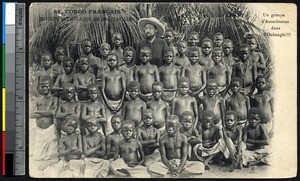 Missionary father poses with group of boys, Central African Republic, ca.1900-1930