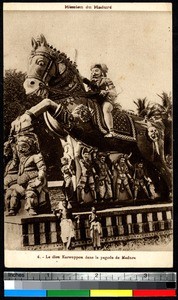Two boys in front of statue of Karouppon, Madura, India, ca.1920-1940