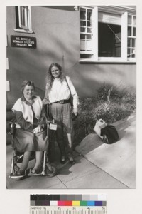 An unidentified woman and Susan O'Hara in front of the U.C. Berkeley Disabled Students Program building