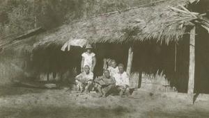 Gabonese people in front of a hut, in Lambarene, Gabon
