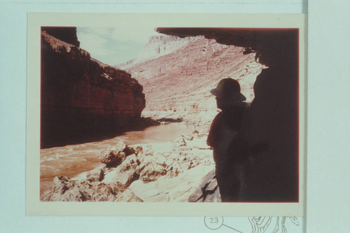 Bill Belknap at the mouth of the cave at Cave Spring Rapid in position similar to Kolb appearing in photo of Nov. 11-13, 1911