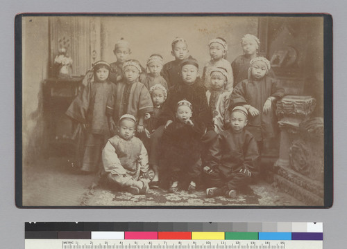 [fourteen children in traditional Chinese dress]