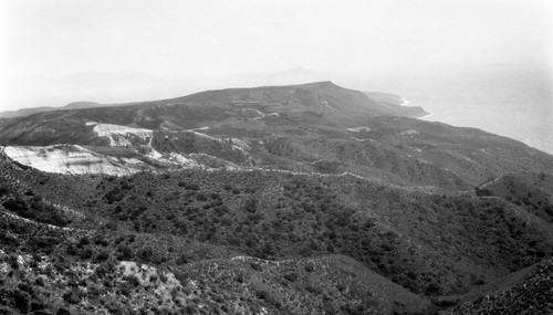 Looking south at great water-worn boulder accumulation from divide 15 miles north of Ensenada