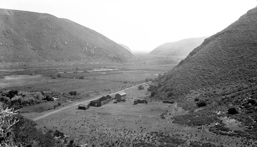 The Mission Santo Domingo from middle hill, facing west with Red Rock in distance