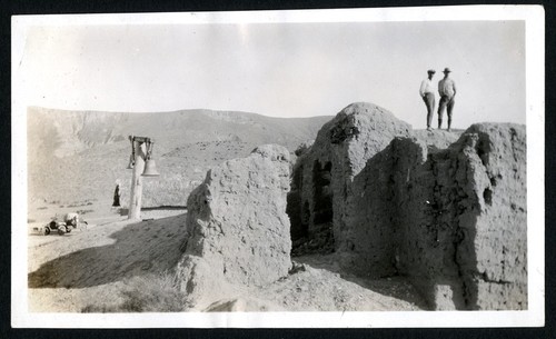 Ruperto Espinoza Arce, the mayor, and Peveril Meigs standing on a wall of the Misión El Rosario de Abajo (second site)