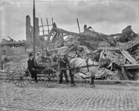 Horse and buggy with men and woman in front of ruins
