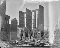Men and women posed in front of ruins