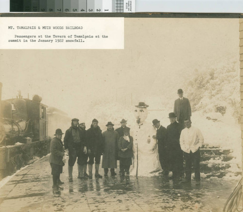 Passengers with snowman at the Tavern of Tamalpais at the summit of Mount Tamalpais in the January 1922 snowfall