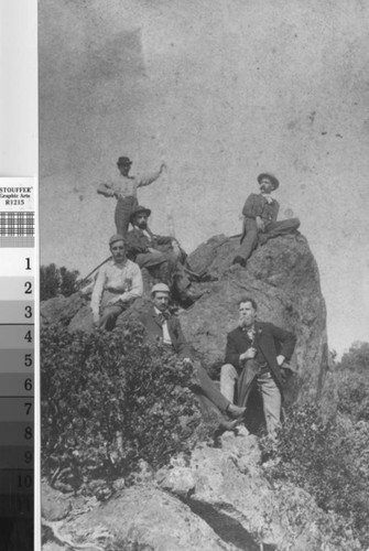 Five men raising a flag at the top of Mount Tamalpais