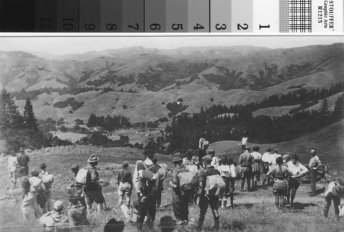 California Alpine Hiking Club members on hike surveying panoramic scene of valley and mountains