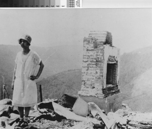 Lucille Frank Hughes in front of burned home on Middle Ridge after the 1929 fire