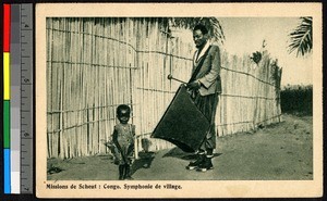 Drummer standing near a small child, Congo, ca.1920-1940