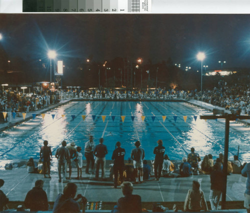 [Swim meet at nighttime photograph]