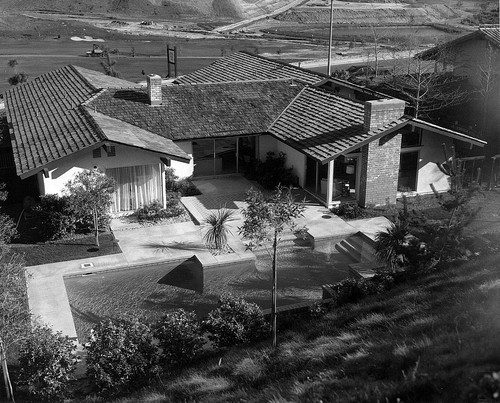 [Mission Ridge model home backyard with swimming pool and back exterior of house photograph]