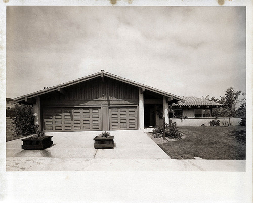 [Mission Ridge model home exterior with raised panel garage doors, plan 13 photograph]
