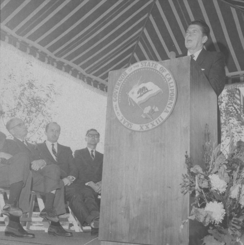 [Ronald Reagan speaking behind a lectern at Saddleback College dedication photograph]