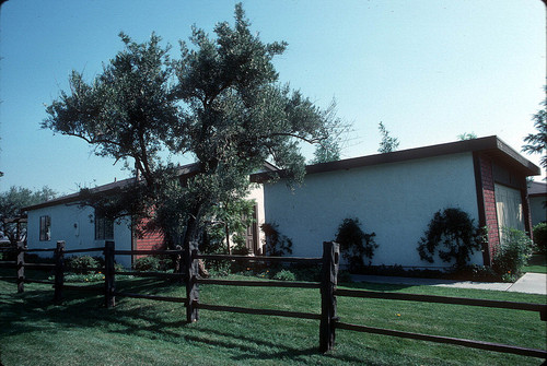 [Cordova model home exterior, two buildings with split rail fence slide]