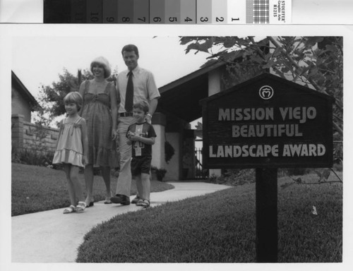 [Mission Viejo Beautiful Landscape Award sign with family on walkway photograph]