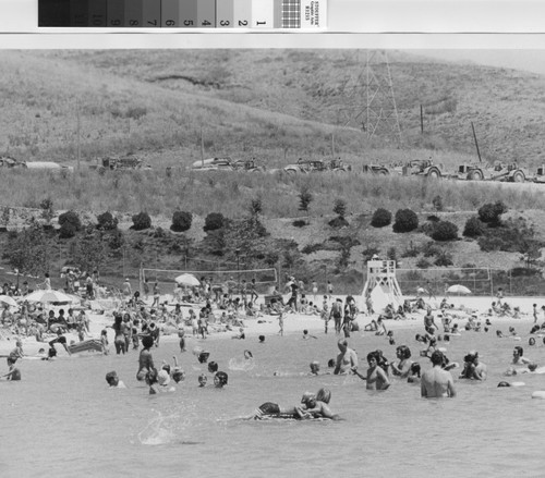 [Lake Mission Viejo beach with swimmers and sunbathers, circa 1979 photograph]