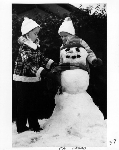 [Children building a snowman at Sierra Snow Day, 1981 photograph]