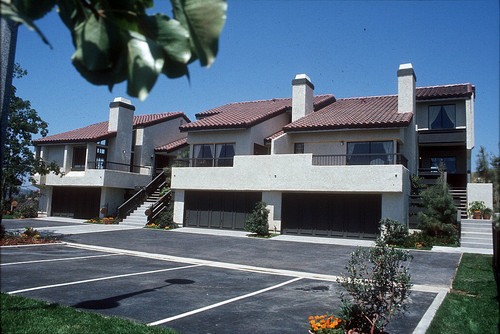 [La Mancha Townhomes model home exterior, multiple units slide]