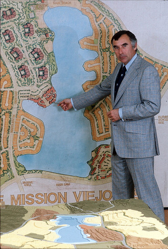 [Philip J. Reilly standing in front of plan for Lake Mission Viejo slide]