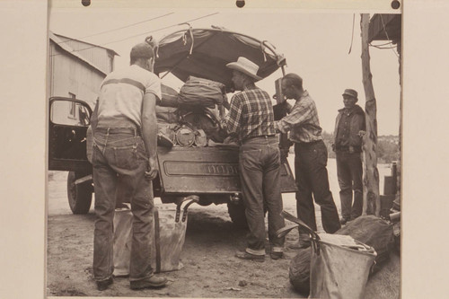 Loading the Power Wagon to run out to the edge of Rainbow Plateau to meet the stock- Ralph Cameron, Bill Belknap, Jorgen Visbak and Bahe; Navajo Mountain Trading Post