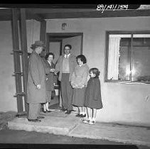 A man giving keys to a family