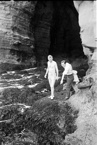 Marston Sargent a biologist at Scripps Institution of Oceanography and C.K. Tseng who would later be known as Zeng Chen-Kui a marine biologist in the Peoples Republic of China, depicted here collecting Gellidium (a type of seaweed) in the La Jolla Caves in La Jolla, California. Circa 1946-1948