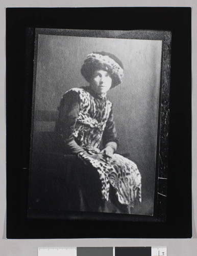 Portrait of Charmian London in a leopard skin dress and hat