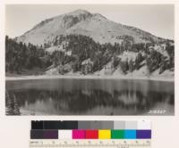 Looking across Lake Helen at Mount Lassen. Pure mountain stand surrounding lake. Scrubby growth on higher slopes in Whitebark pine