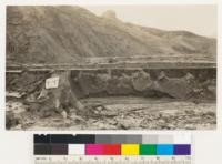 San Francisquito Dam. Silt deposits in reservoir bed about 200 feet above dam. Carrying case on top of oak stump indicates depth. This material was eroded from ravines in resevoir by outrushing water which was arrested sufficiently by the very narrow exit at the lower levels to account for this deposition