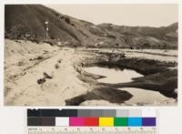 San Francisquito Dam flood. Road and levee right angle to flood resulted in silt deposit 6" to 2 feet deep above and erosion below as shown