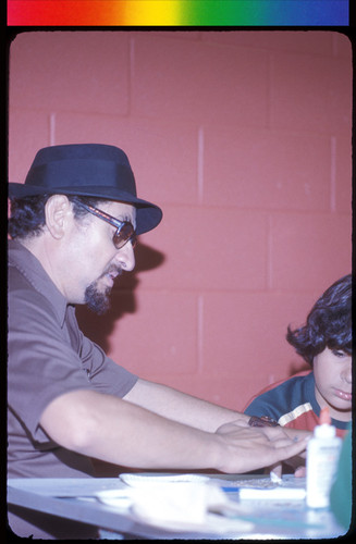 Professor Montoya Demonstrating Use of Glue, Scissors, etc., to Barrio Art Children