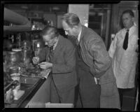 Dr. Frank R. Webb inspects remains from murder site as Ray Pinker observes, Los Angeles, 1938