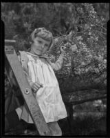 Mary Lou Carter with the blooming wisteria plant, Sierra Madre, 1936