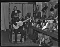 Officers S. F. Carter and J. V. Anderson pose with unclaimed items for sale at the semi-annual police auction, Los Angeles, 1938