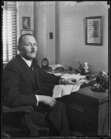 Dutch consul Adrian Hartog seated in his office, Los Angeles, 1930