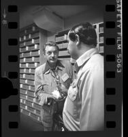 Police officer Robert Martinez returning stolen Oscar statue to costume designer, Bill Thomas in Los Angeles, Calif., 1976