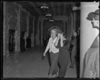 La Mae Holland leaving the courtroom, Los Angeles, 1935