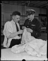 Colonel Roscoe Turner and Guy Ball prepare the giant parachute, Los Angeles, 1935